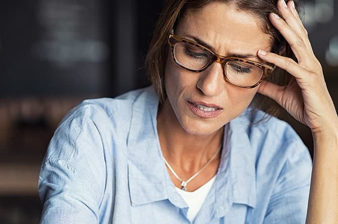 Stressed woman suffering from migraine