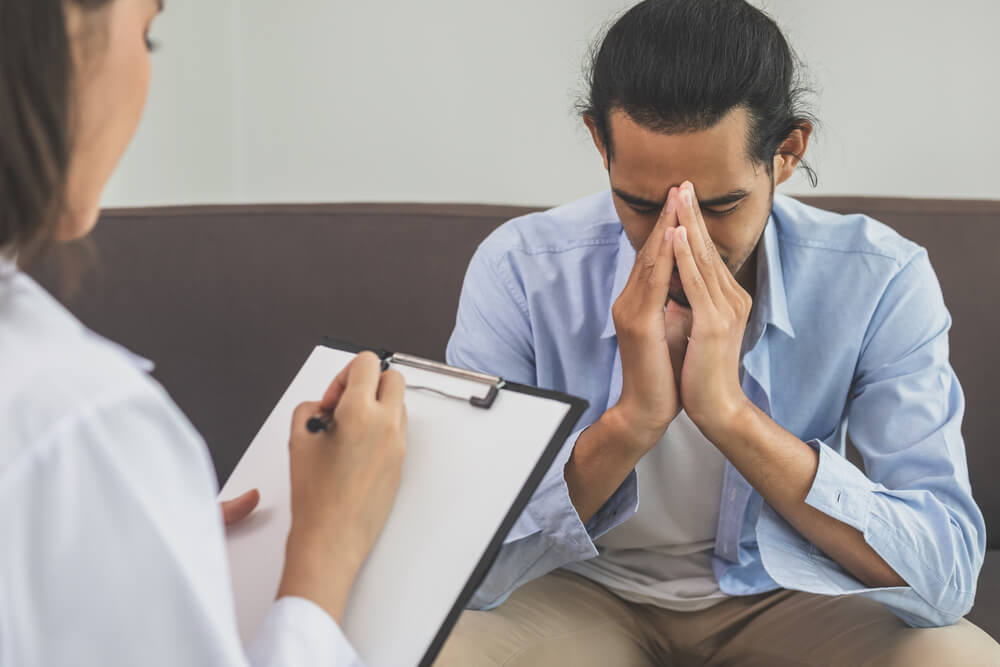Man suffers from depression and anxiety, having a consultation with a Psychiatrist.