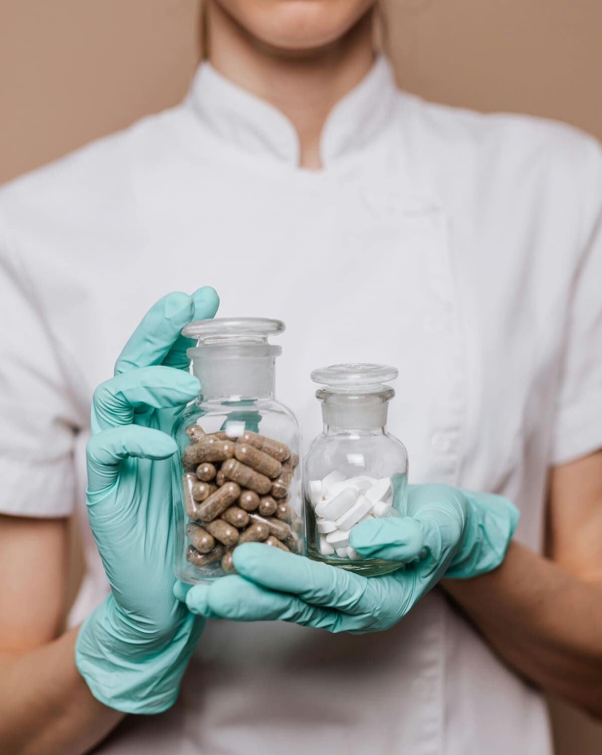 Woman Holding Two Clear Bottles with Medicines